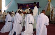 Br Emmanuel (3rd from left) kneels during his Final Profession ceremony at St Andrew's Cathedral, Wa.